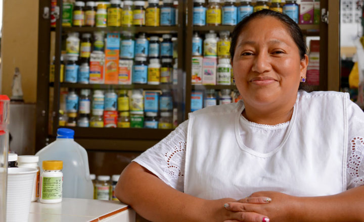 Ecuadorian woman from indian heritage posing in front of the camera in her market stall selling drugs at the public market.