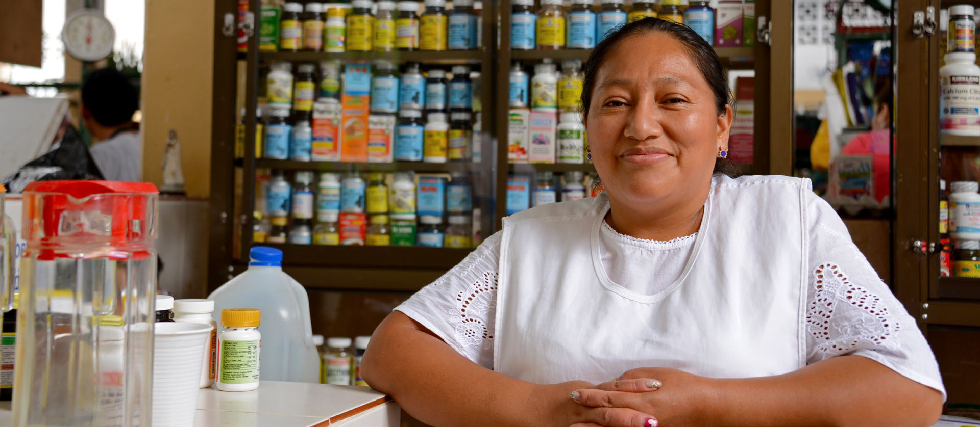 Ecuadorian woman from indian heritage posing in front of the camera in her market stall selling drugs at the public market.